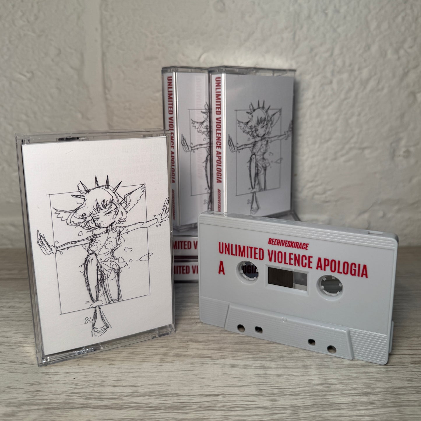“Unlimited Violence Apologia” Cassette (Light Grey)